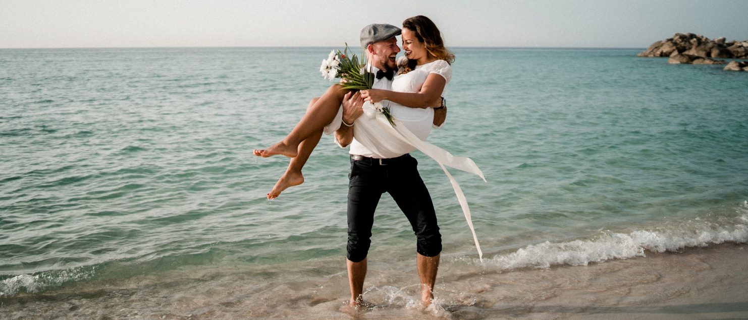 Bride and Groom having fun on the beach