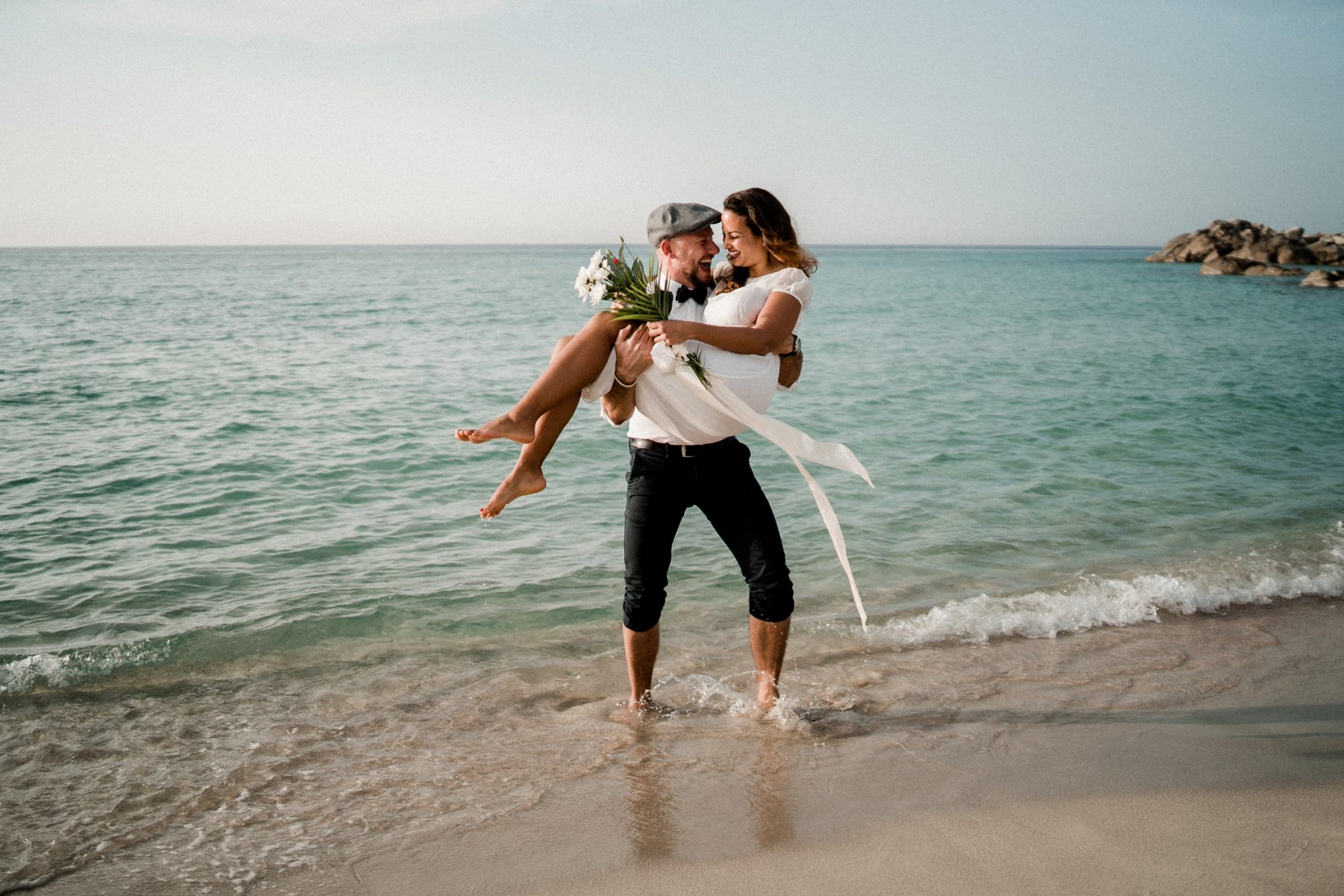 Bride and Groom having fun on the beach